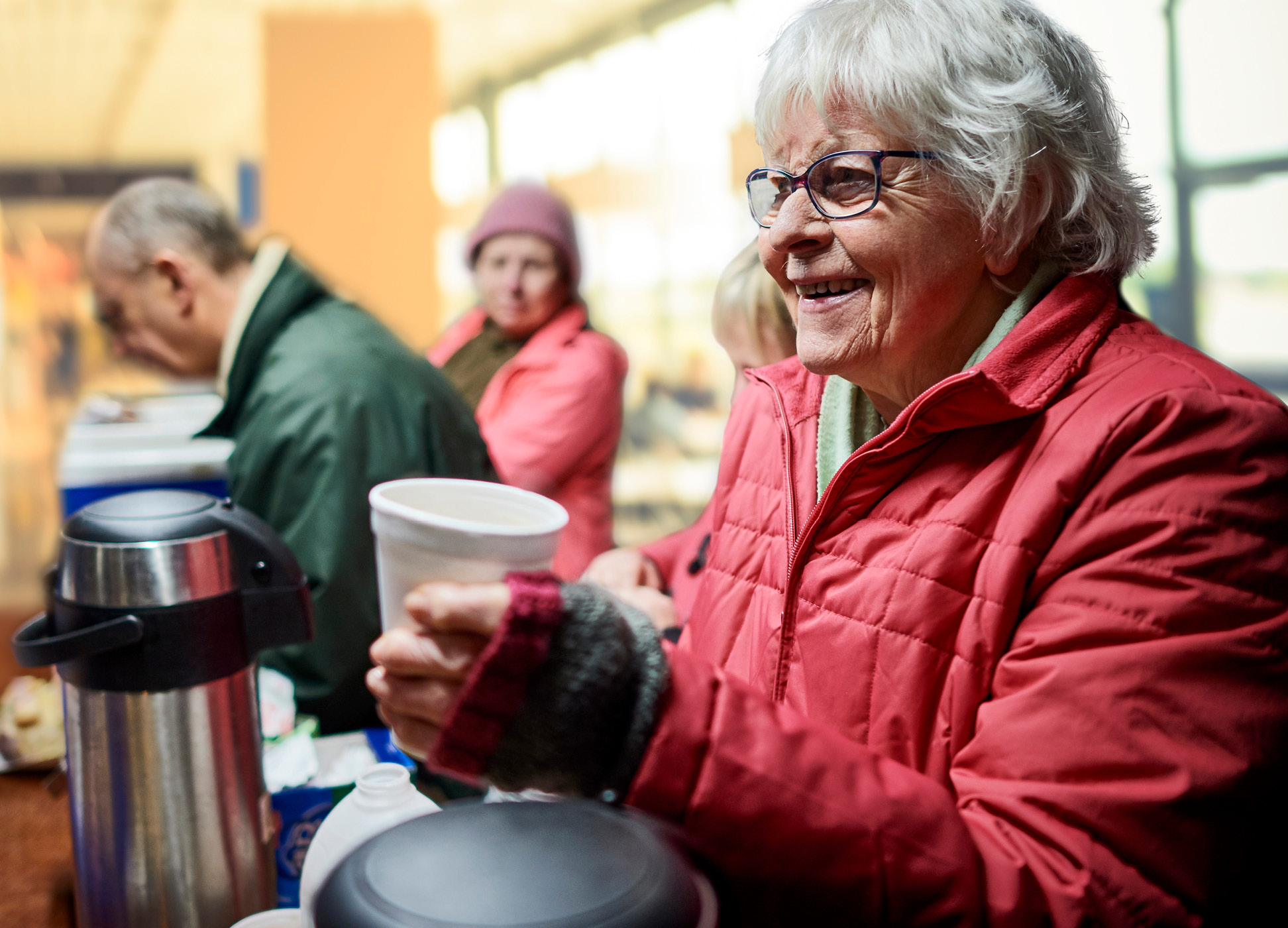 elderly people in a coffee and food line